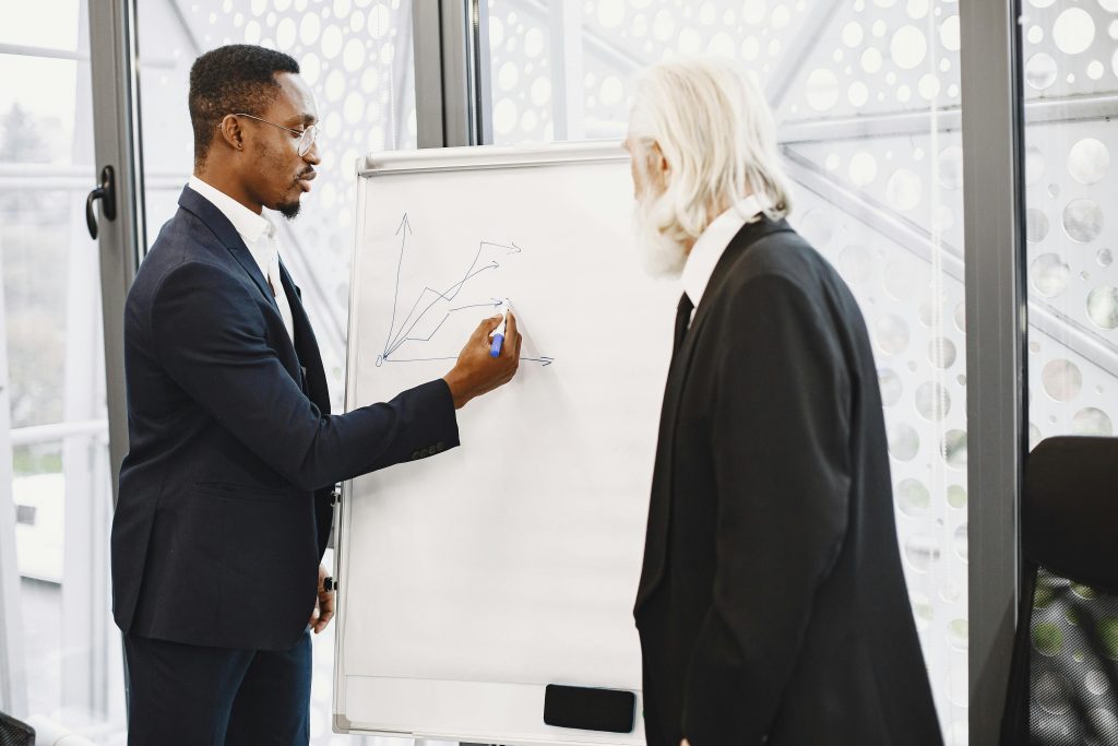 Two business professionals collaborating on a growth strategy in a modern office setting.